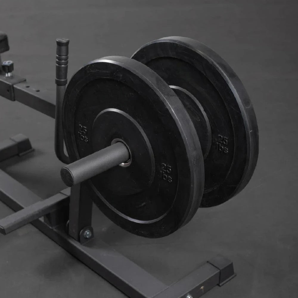 Plate loaded calf raise machine on a dark floor