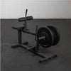 Black weight bench with weights on a gray floor against a white wall