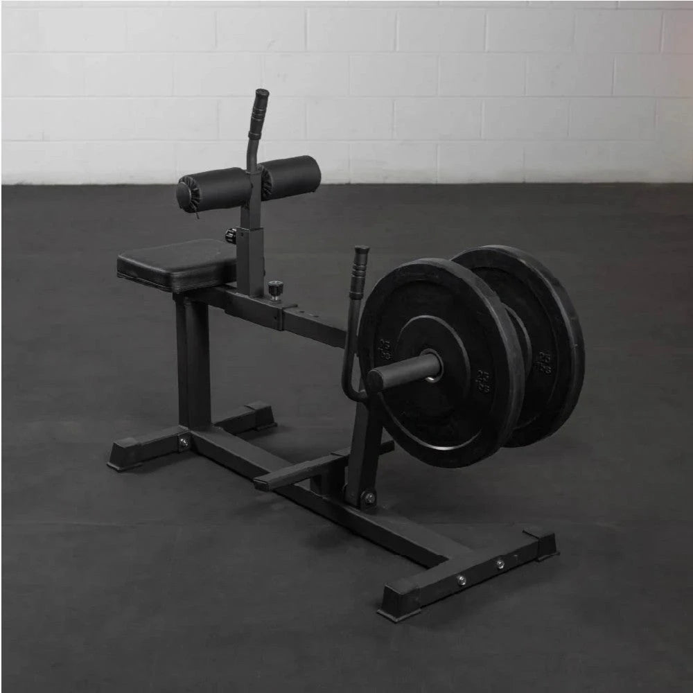 Black weight bench with weights on a gray floor against a white wall
