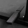 Close-up of a black metal foot rest on a textured surface