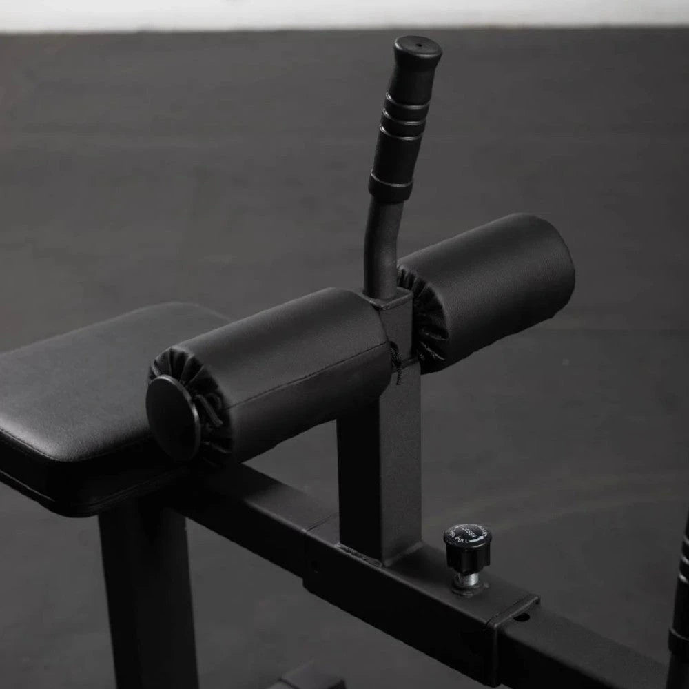 Knee pad adjustment with pop pin and release handle assembly of a calf raise machine