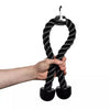 Hand holding a black rope pull attachment for gym equipment on a white background