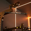 Gym cable machine with straight bar attachments against neon lights