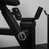 Close-up of a black exercise machine with a focus on the seat post and control knob.