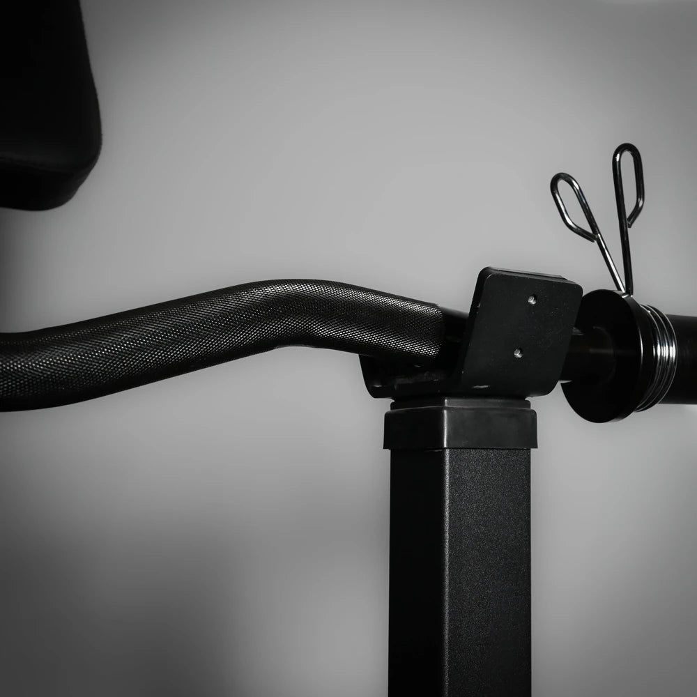 Barbell in holder on a preacher curl bench