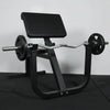 Preacher curl bench with barbell and weights in a gym setting