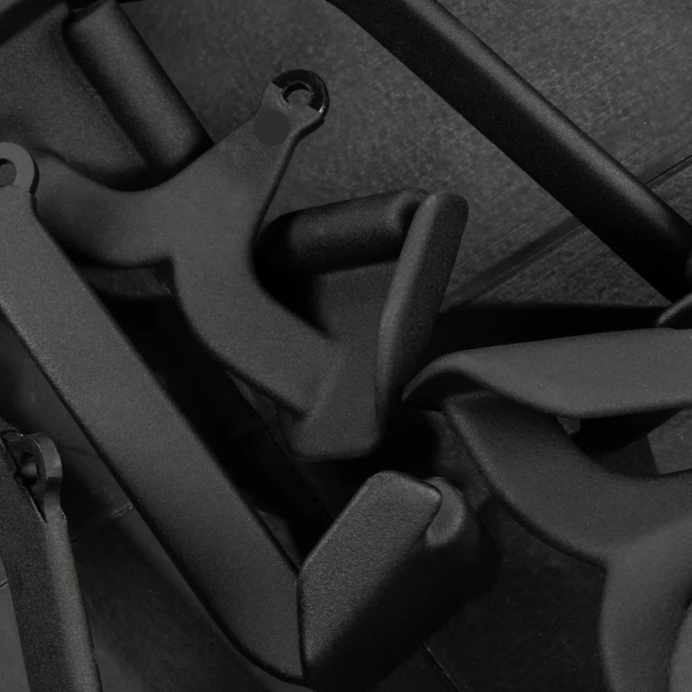 Black metal cable attachments on a dark background