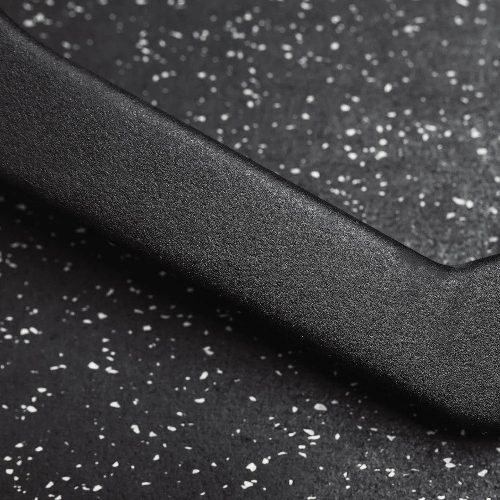 Close up of metal part of cable attachment bar on a dark background