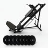 Black steel frame leg press with set of weights on a white background