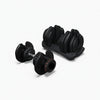 Dumbbell weights with a dial weight adjustment on a white background