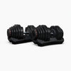 Set of adjustable dumbbells with stands on a white background