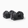 Set of black adjustable dumbbells on a white background