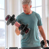 Man holding dumbbells in a home enviroment