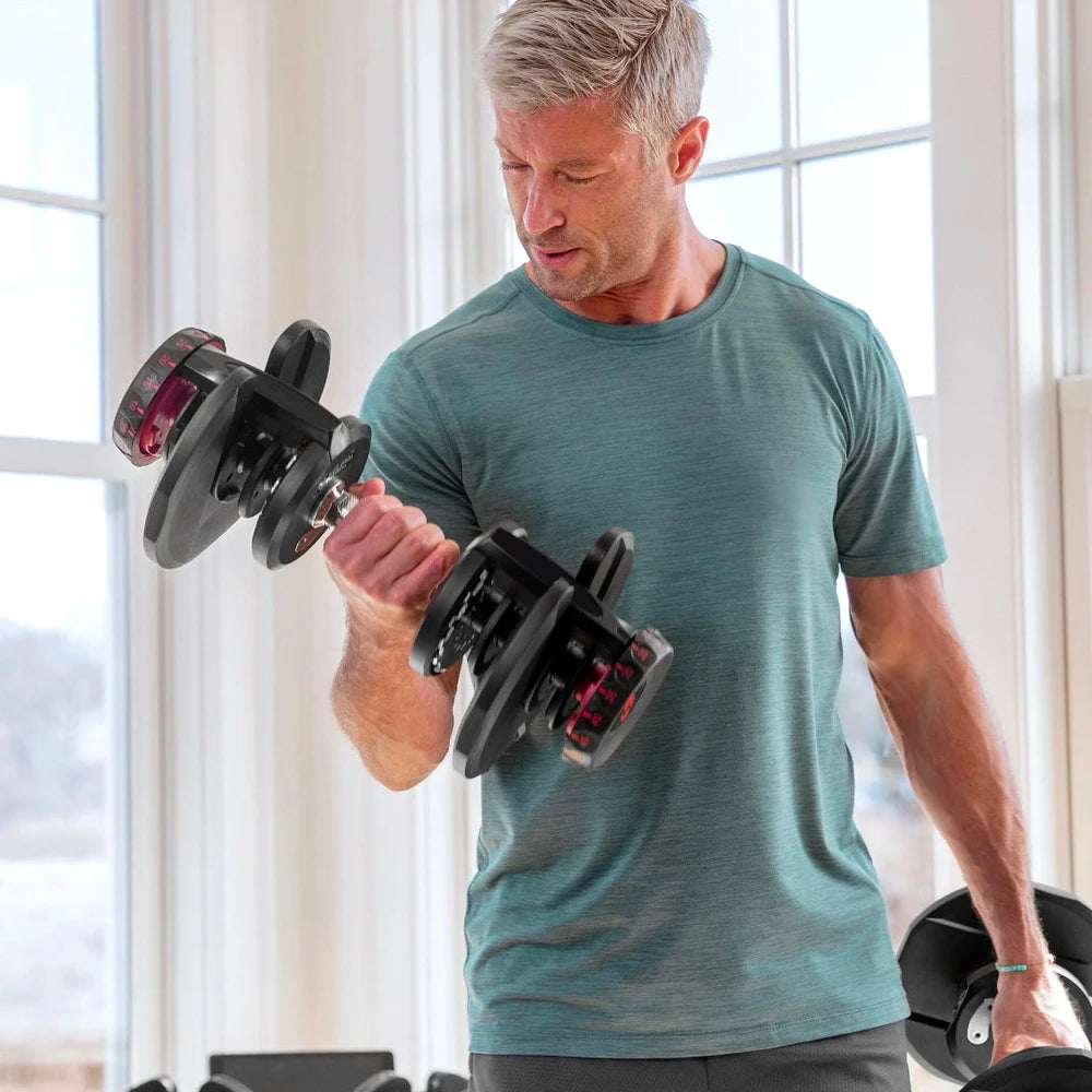 Man holding dumbbells in a home enviroment