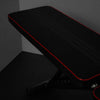 Close up of gym bench back cushion in black with red piping
