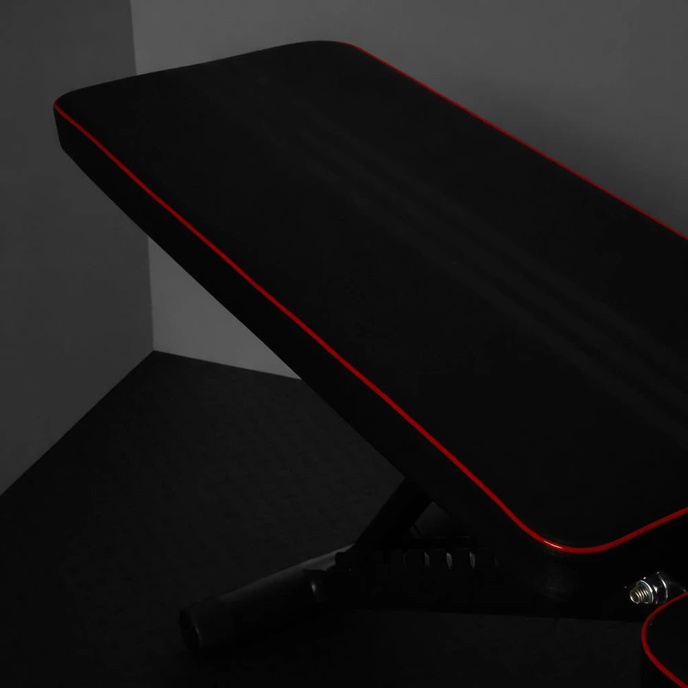 Close up of gym bench back cushion in black with red piping
