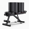 Image showing heavy duty gym bench with stacked weight plates on top