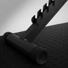 Close up of adjustable gym bench detail on a textured black floor