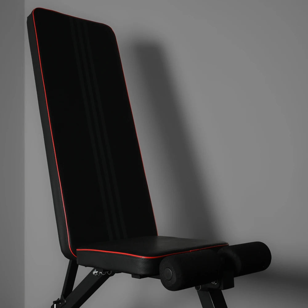 Black gym bench with red piping in upright position