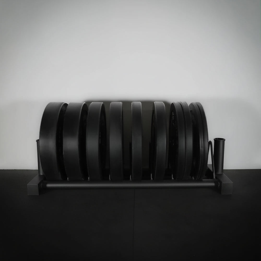 Full weight plate rack on black floor and grey wall