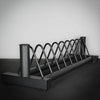 Metal weights rack on a dark surface with a light gray background
