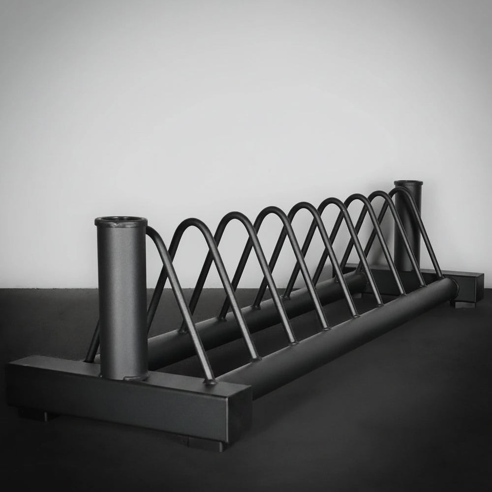Metal weights rack on a dark surface with a light gray background
