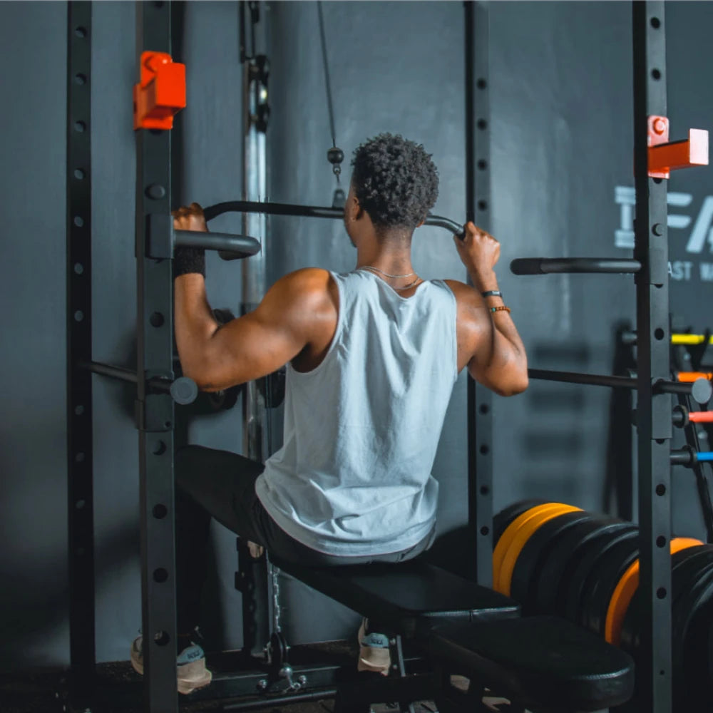 Person exercising on a pull-up bar in a gym setting