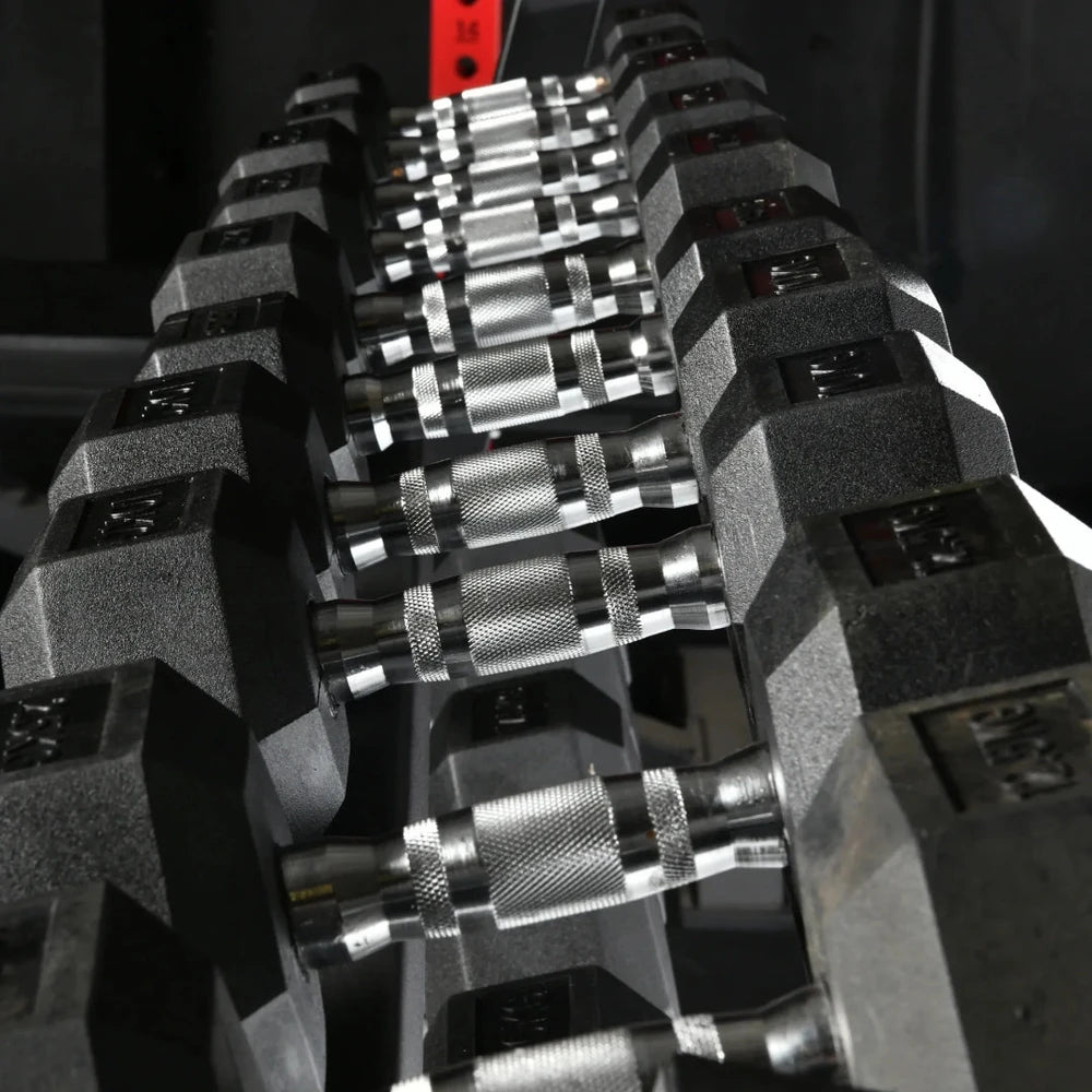 Row of hex dumbbells in a dark gym setting