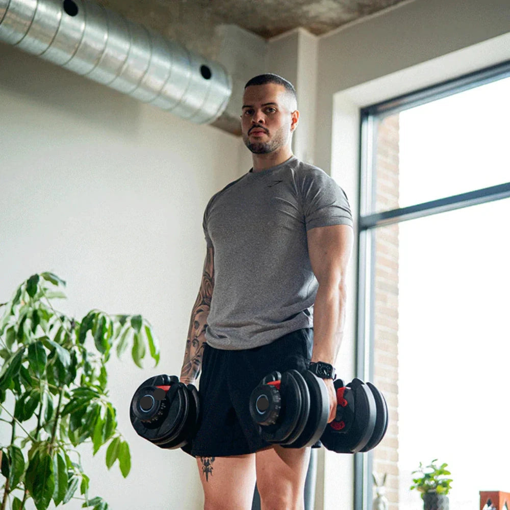 Man holding a pair of adjustable dumbbells in a gym setting
