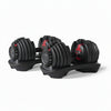 Pair of adjustable weighted dumbbells on stands on a white background