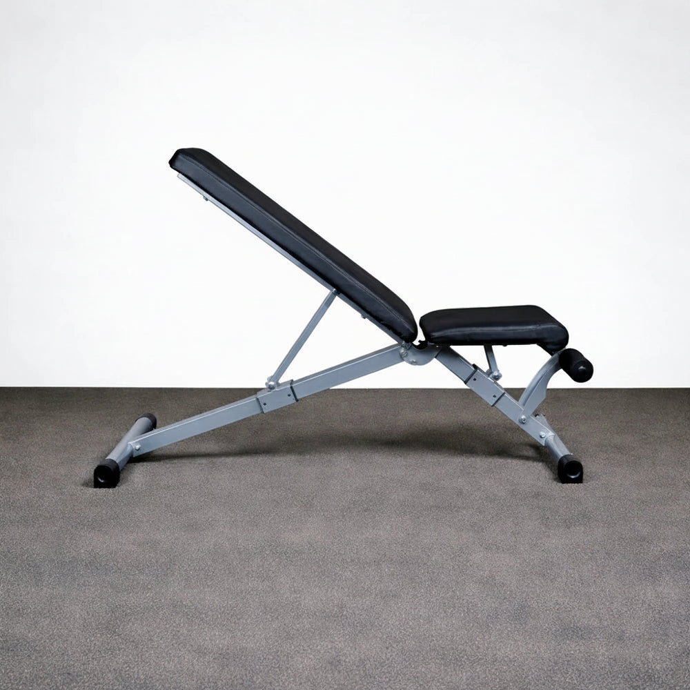 Black adjustable weight bench on a gray floor with a white background