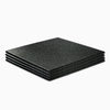 Set of black heavy duty gym floor mats on a white background