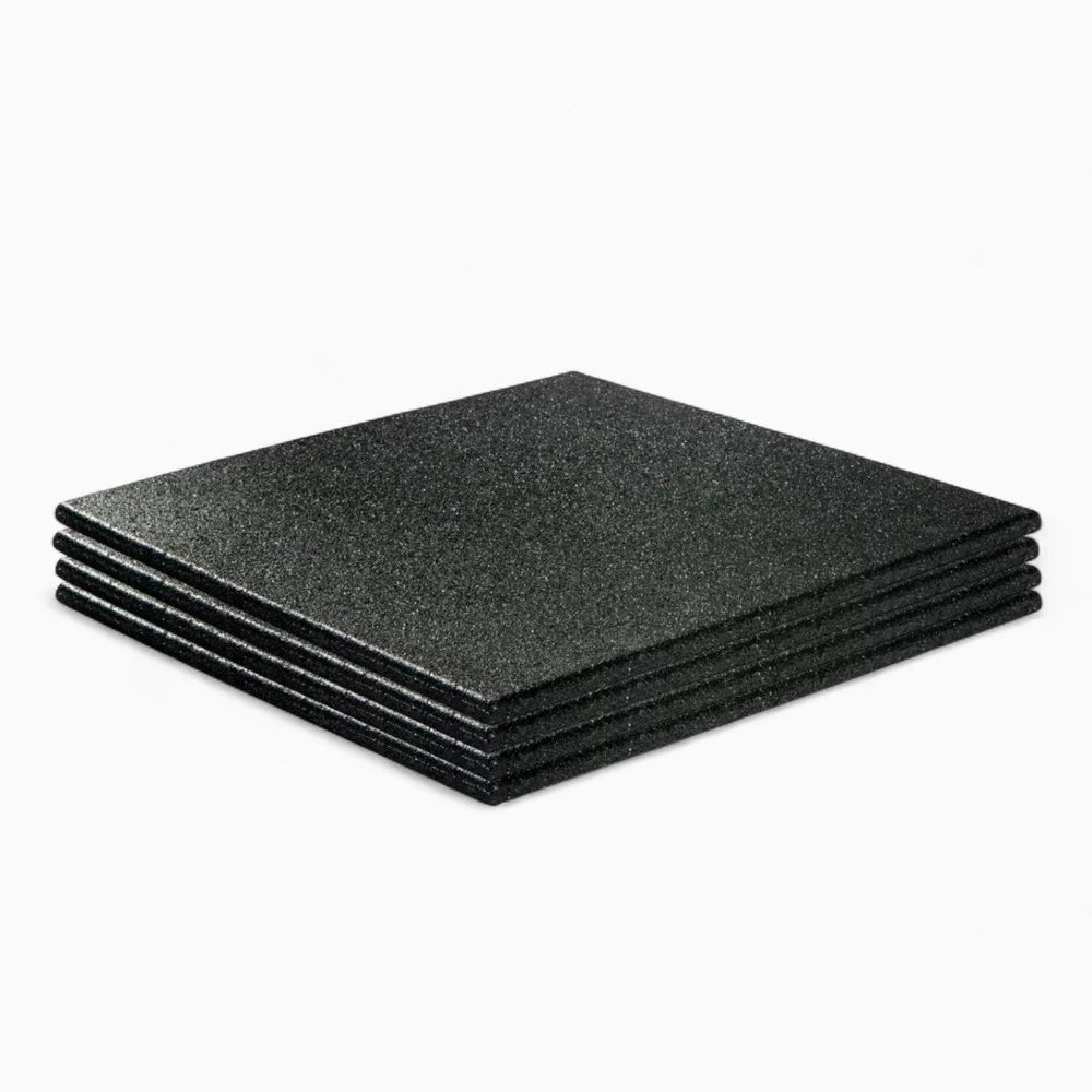 Set of heavy duty black rubber floor tiles on a white background