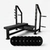 Black steel frame flat weight lifting bench with weight plates on a white background