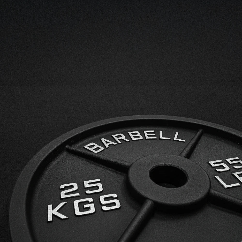 25kg barbell weight plate on a black background
