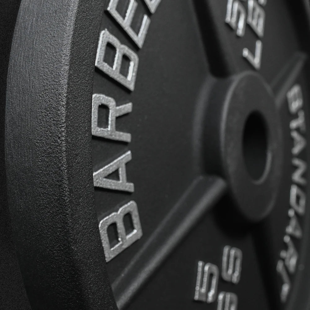Close up of embossed writing on a black barbell weight