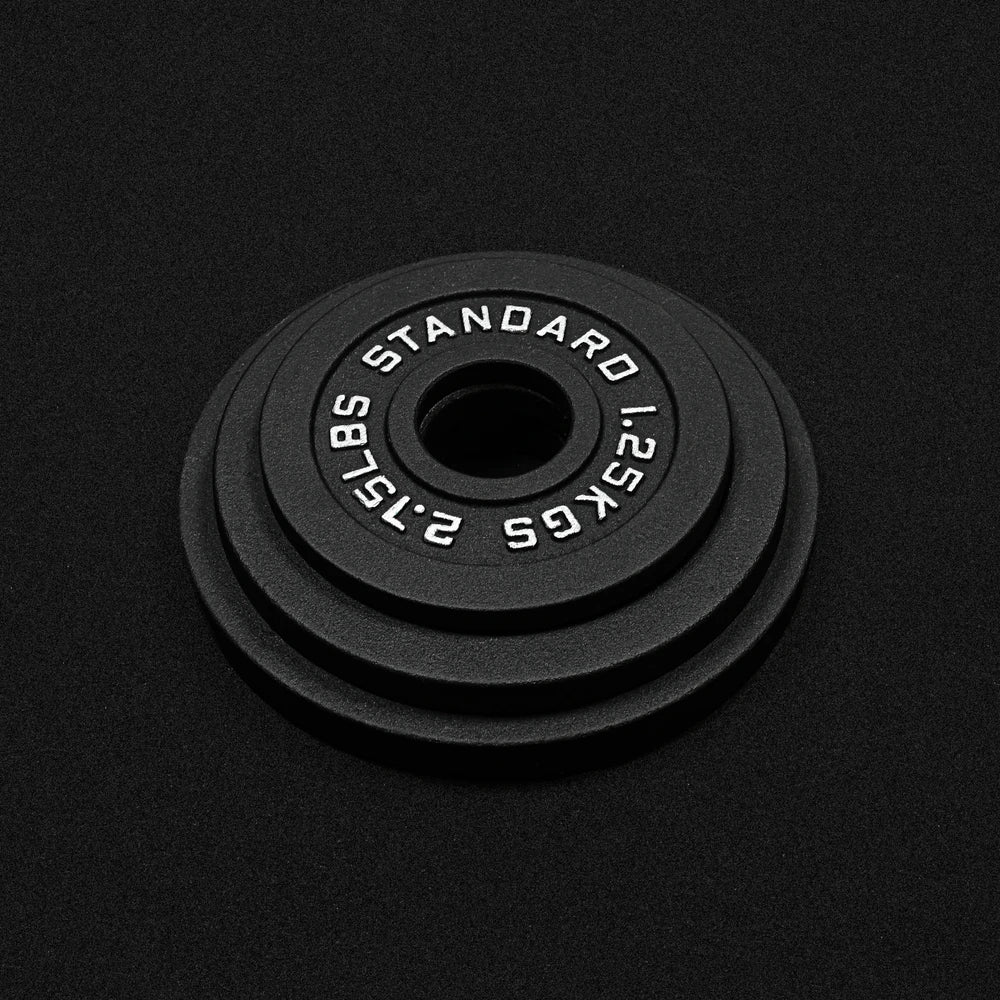 Set of 3 black barbell weight plates on a black background