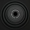 Set of different sized black weight plates on a black background