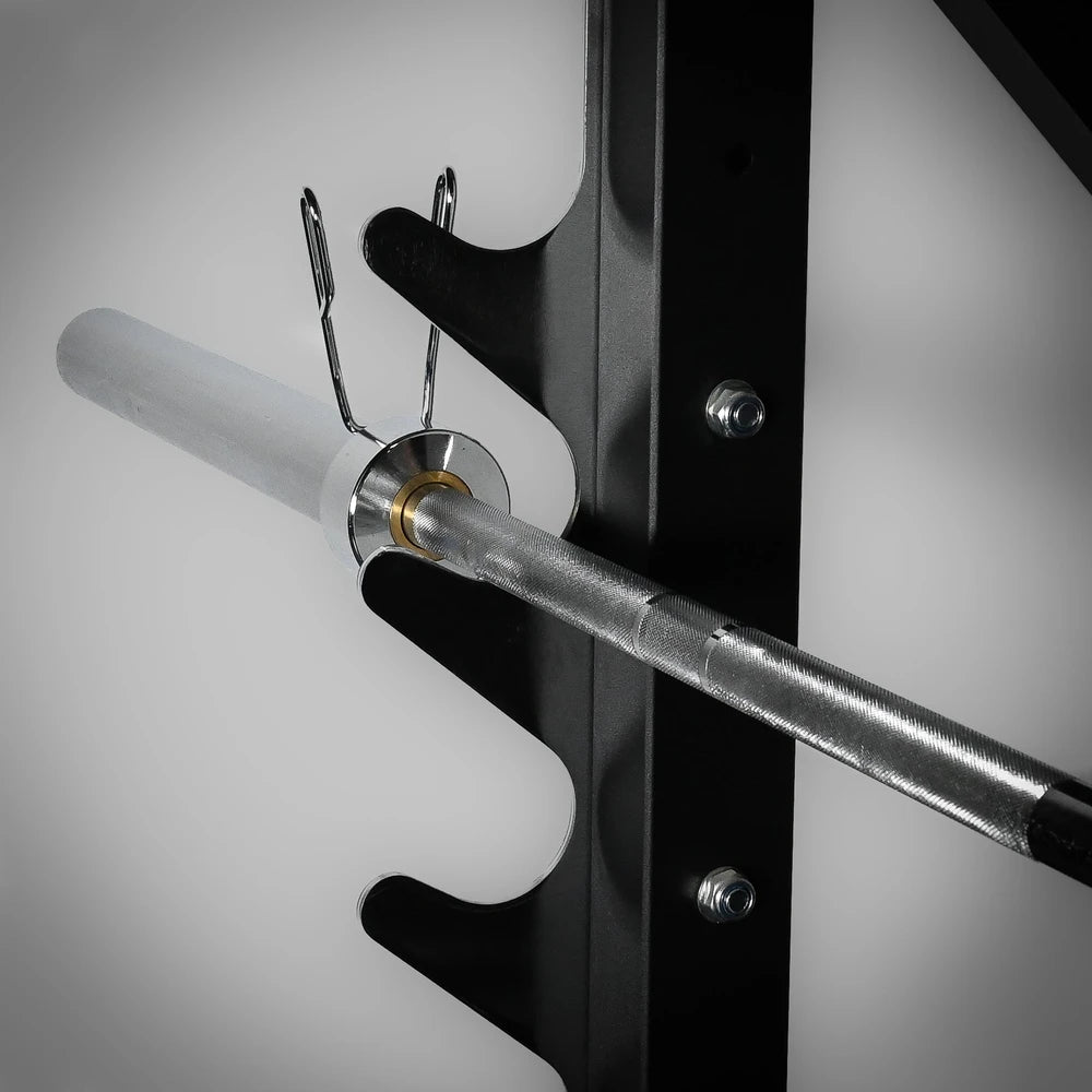 Metal barbell attached to a black rack on a gray background
