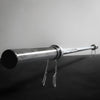 Silver barbell on a dark surface with a gray background
