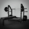 Weight bench with barbell and weights on a gray background