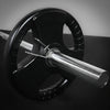 Barbell with weight plate on a silver and black background