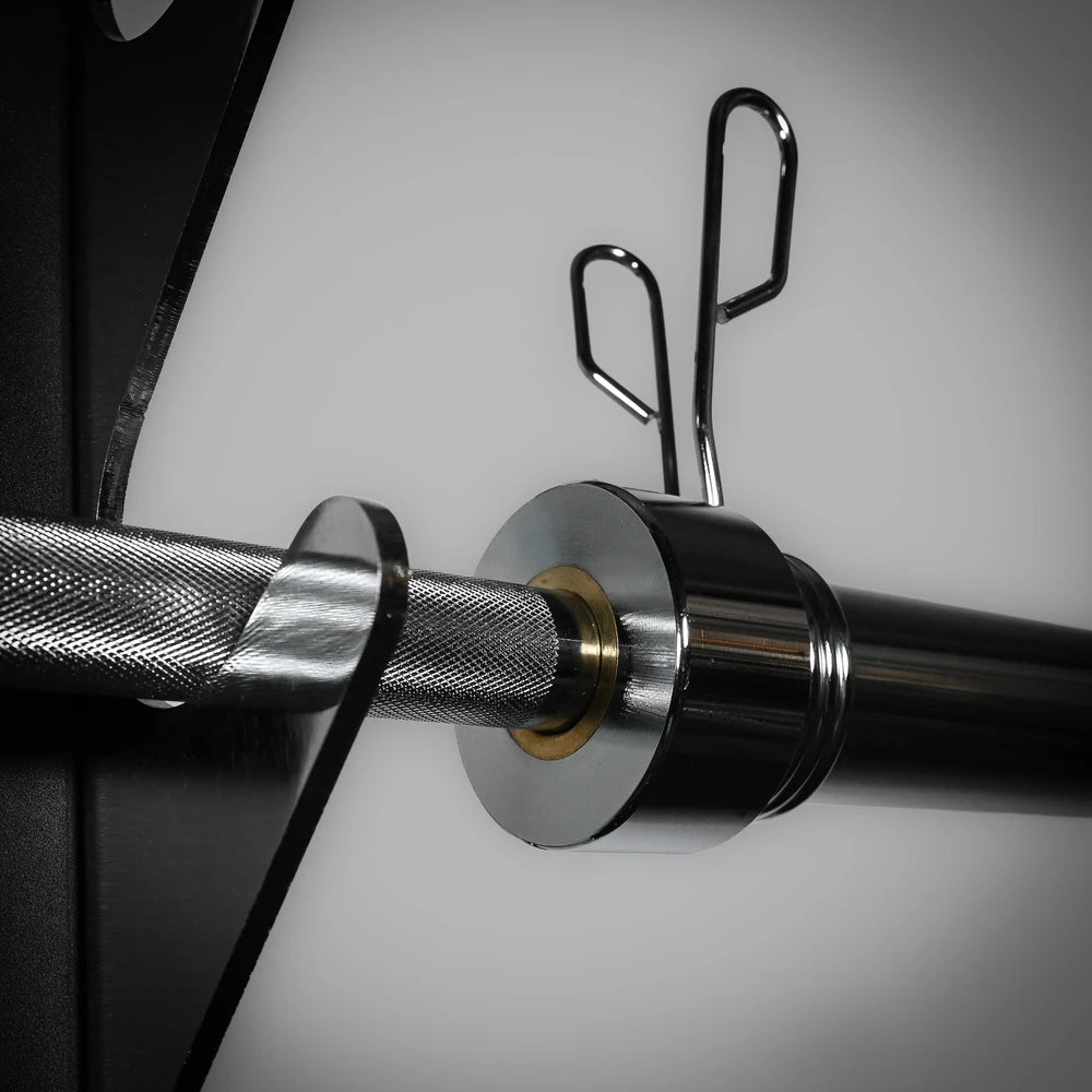 Close-up of a barbell with weight plates on a neutral background