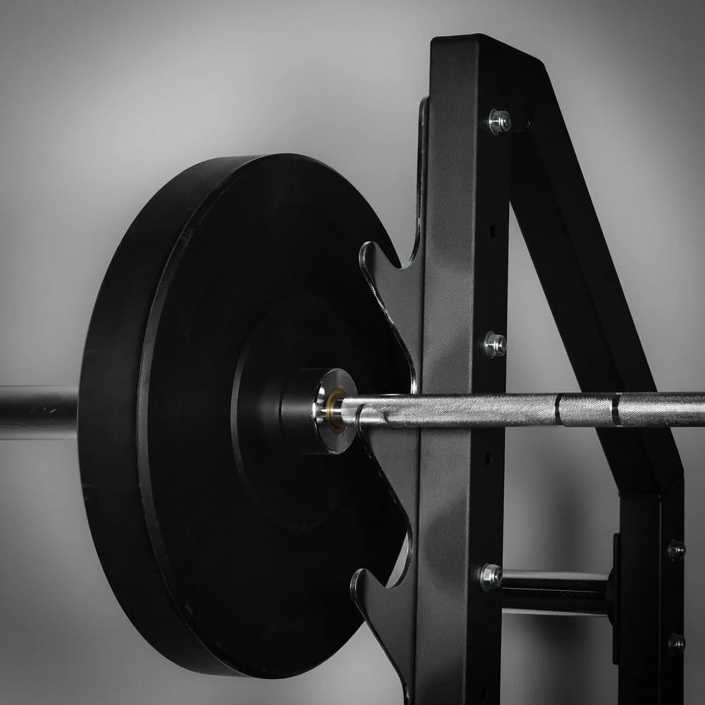 Close-up of a barbell with weight plates on a gray background