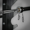 Metal barbell with hooks attached to a black metal frame on a gray background