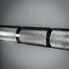 Close-up of barbell with a textured surface on a gray background