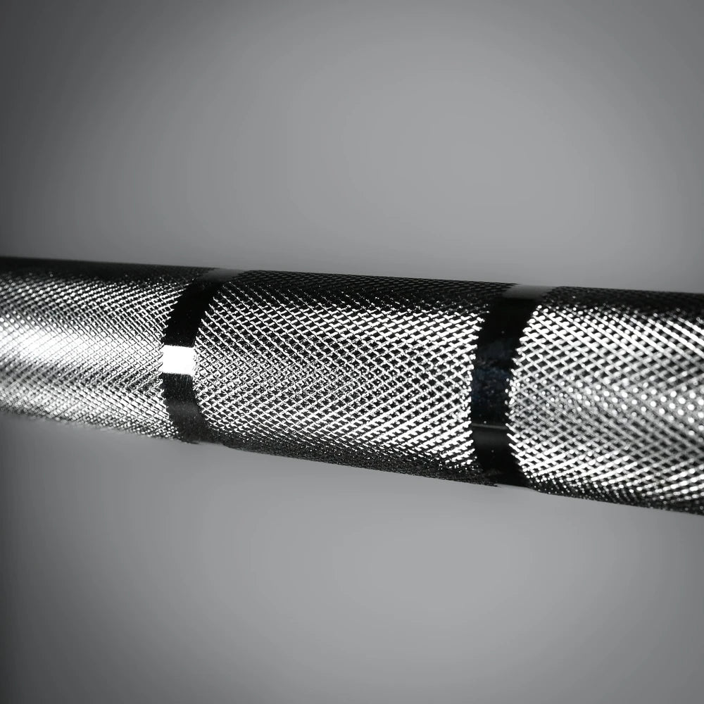 Close-up of barbell with a textured surface on a gray background