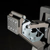 Close-up of a metallic mechanical device with visible branding on a black background