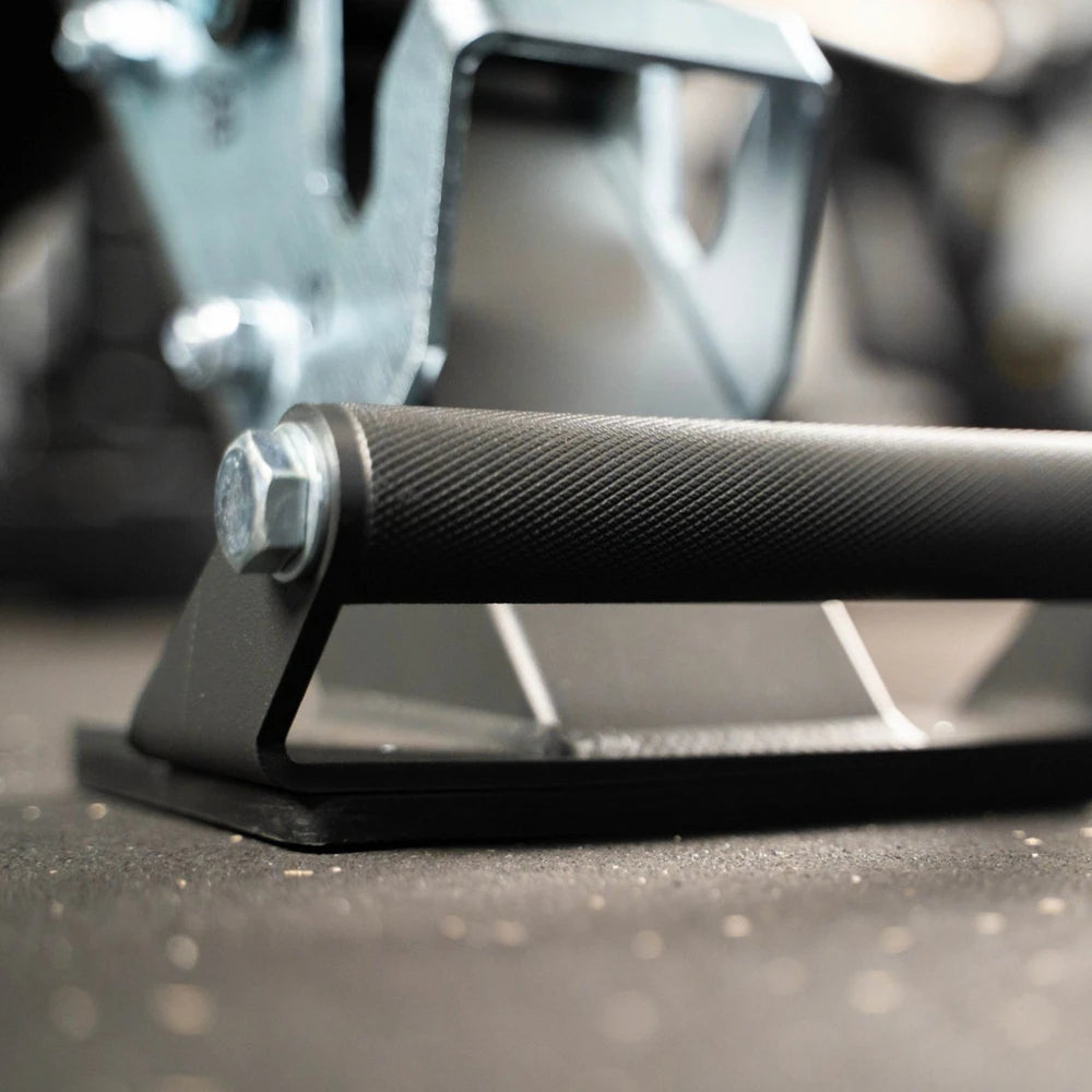 Close-up of a gym bench with a textured grip and a bolt, blurred background