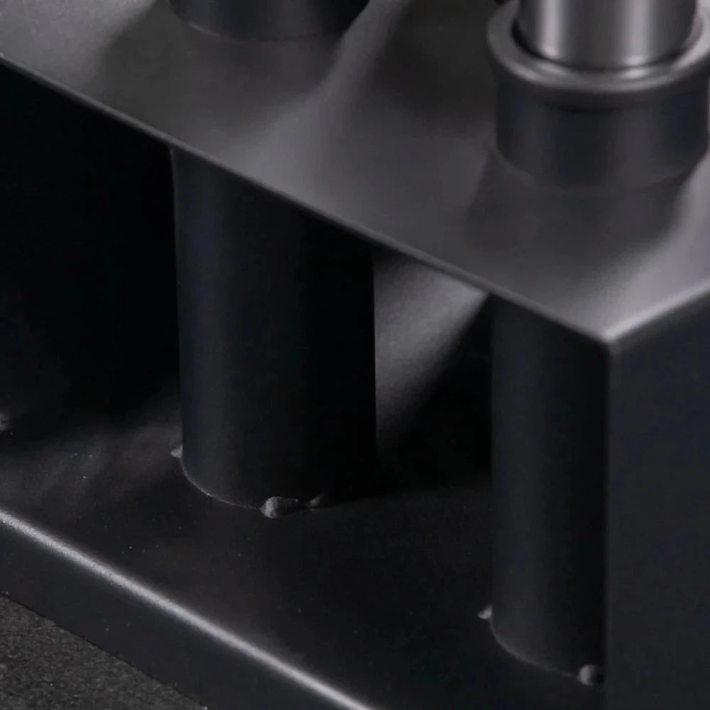 Close-up of a black metal barbell holder with cylindrical components.
